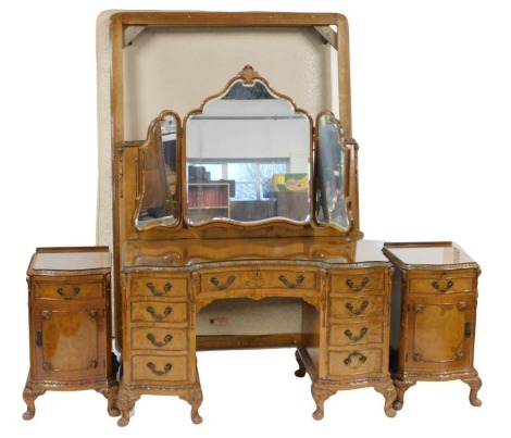 A George II style walnut and burr walnut bedroom suite, comprising dressing table with triple shield shaped mirrored back with bevelled edges, the inverted base with a carved border with an arrangement of drawers, on short carved cabriole legs with pad fe