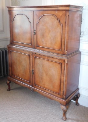 A Queen Anne style walnut cocktail cabinet, the top with a moulded edge above two hinged doors enclosing a shaped shelf picked out in gilt with green interior and sliding drawer, the base with two cupboards enclosing a shelf to each top, on shell carved l - 3