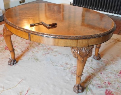 A George II style walnut extending dining table, the oval burr top with a carved edge, raised on four shell and scroll carved legs with raised beading, on hairy paw feet, 75cm high, the top 121cm x 150cm, with winder, together with a set of ten Queen Anne - 3