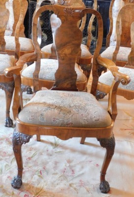 A George II style walnut extending dining table, the oval burr top with a carved edge, raised on four shell and scroll carved legs with raised beading, on hairy paw feet, 75cm high, the top 121cm x 150cm, with winder, together with a set of ten Queen Anne - 5