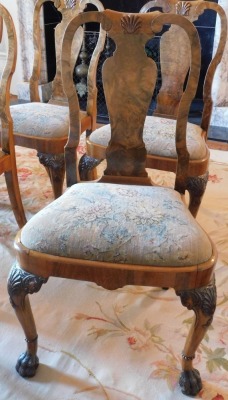 A George II style walnut extending dining table, the oval burr top with a carved edge, raised on four shell and scroll carved legs with raised beading, on hairy paw feet, 75cm high, the top 121cm x 150cm, with winder, together with a set of ten Queen Anne - 6