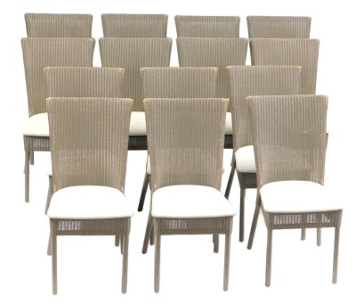 A set of fourteen Lloyd Loom of Spalding wicker dining chairs, each with a tapering high back, overstuffed seat, on turned legs, painted in taupe, bearing brass plaque.