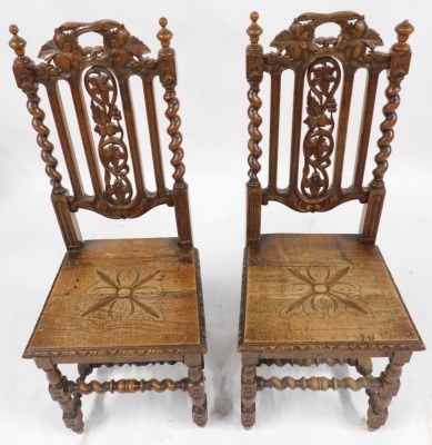 A pair of Victorian oak dining chairs in 17thC style, each with a pierced carved leaf and fruit back, with spiral twist supports with solid seat, on turned and carved legs united by spiral turned stretchers.  - 2