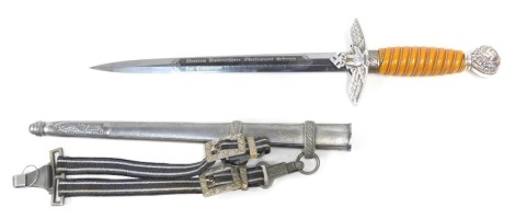 A German Third Reich Luftwaffe dagger, the pommel bearing oak leaves and swastika motifs above an amber ivorine grip interspersed with twisted steel wire decoration, the hilt bearing a spread-eagle holding a swastika, the Solingen steel blade bearing scri