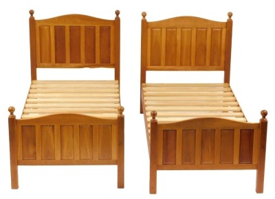 A pair of Horace Knightman Knight of Thirsk oak single bed frames, comprising head, foot and slatted base, with carved knight to each footboard.