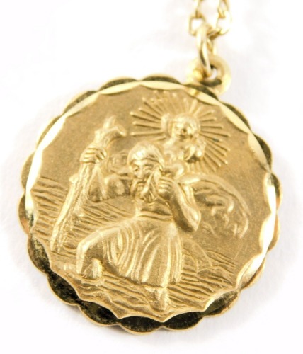 A 9ct gold pendant and chain, the St Christopher circular pendant reverse inscribed with a car and aeroplane, 2.5cm diameter, on curb link neck chain, 60cm long, 11g.