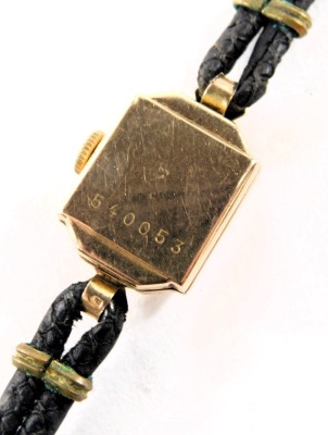 A 9ct gold cased lady's cocktail watch, with a square dial with silvered backing and black hands, 1cm diameter, on a two strand black leather strap, 9g all in. - 3