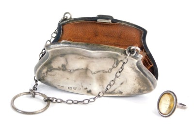 A Victorian or Edwardian silver coin purse, enclosing a brown leather concertina section, with metal chain and finger ring, Chester hallmarks rubbed, 8cm wide, together with a faceted stone set silver ring. (2)