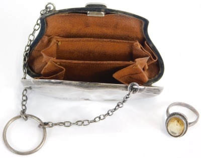 A Victorian or Edwardian silver coin purse, enclosing a brown leather concertina section, with metal chain and finger ring, Chester hallmarks rubbed, 8cm wide, together with a faceted stone set silver ring. (2) - 4