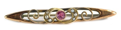 A 9ct gold topaz and seed pearl bar brooch, the central pink topaz flanked by seed pearl set scrolls, the brooch of compressed rectangular form, marked 9ct, 4.5cm long.