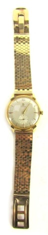 An Omega gentleman's automatic wristwatch, with a silvered dial and baton outer border, subsidiary seconds dial, in yellow metal case stamped 18ct, movement number 10974433, on a 9ct gold tapered block link bracelet with safety fastener, Birmingham 1960, 