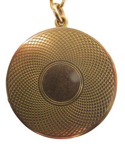 A 9ct gold circular pendant and chain, the circular locket with engine engraved outer case, 3cm wide, on byzantine link neck chain, 44cm long, 15.7g. all in.