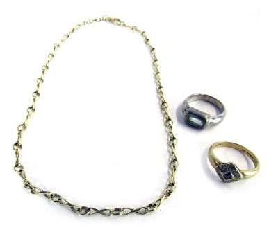 Three items of jewellery, comprising a 9ct gold dress ring, the square set panel set with tiny diamonds and central blue stone in rub over setting, 2.5g all in, a gold plated neck chain, and a silver dress ring. (3)