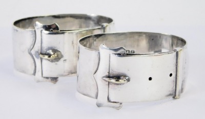 Two George V napkin rings, of buckle and strap oval form, numbered 4 E-9, silver plated, bearing initials A & J. - 2