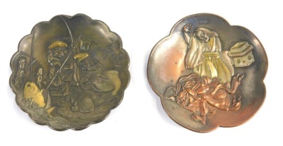 Two late 19th/early 20thC Japanese mixed metal trinket dishes, each with a petalated border, one embossed with a depiction of two fisherman spearing a fish, the other with a figure of a lady with arm raised beside a demonic figure, with heightened brass d