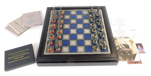 A Waterloo Museum The Battle of Waterloo chess set, the blue and silver coloured chequered chess board containing cast pewter figures, together with presentation booklets and related paperwork.