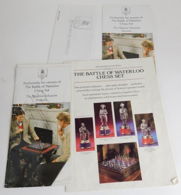 A Waterloo Museum The Battle of Waterloo chess set, the blue and silver coloured chequered chess board containing cast pewter figures, together with presentation booklets and related paperwork. - 2