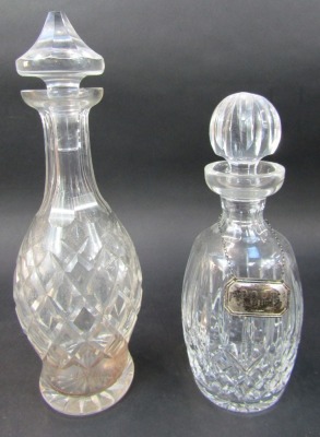 A group of cut glass decanters, comprising decanter of mallet form with stopper, 33cm high, two similar decanters of bottle form, with stoppers, one Waterford, 33cm high, together with a cut glass claret jug add stopper, silver port label, etc. - 3