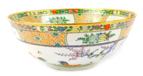 A late 20thC Chinese famille rose porcelain bowl, painted with fruits and flowers border, with cockerel centre design, 25cm diameter.