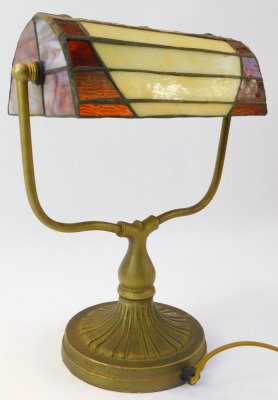 A Tiffany style desk lamp, the leaded glass shade decorated with a tree raised on a cast metal base on circular foot, 35cm high. - 2