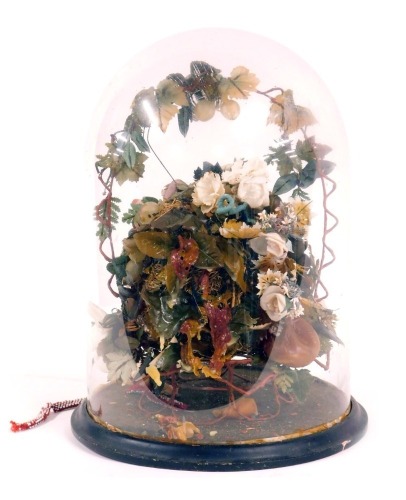 A late 19thC wax and material fruit centrepiece, formed as a still life with central nest and flowers and fruit design, on a black ebonised base with glass dome, 43cm high. (AF)