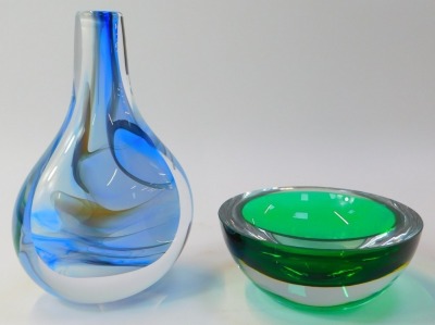 A group of Art Glass, comprising a Swedish glass vase of compressed bottle form, decorated internally in blues and whites signed to base CJ Tinback Sweden, numbered 4833, 22cm high, a green glass Murano bowl, and a green and red glass dog, 33cm high. (3) - 4