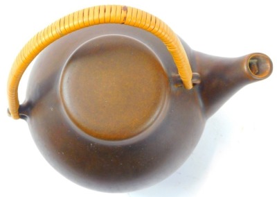 An Arabia pottery Oriental influence teapot, in brown glaze with a wicker handle, stamped to underside Arabia Made in Finland, 16cm high. - 2