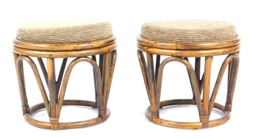 A pair of mid century bamboo framed footstools, each of circular form with a drop in seat, 42cm high.