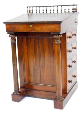 A Victorian rosewood Davenport, the galleried top above a green gilt tooled leather slope enclosing a vacant interior, the base with four drawers to one side and a further four dummy drawers to the other supported by turned columns, on castors, 92cm high,