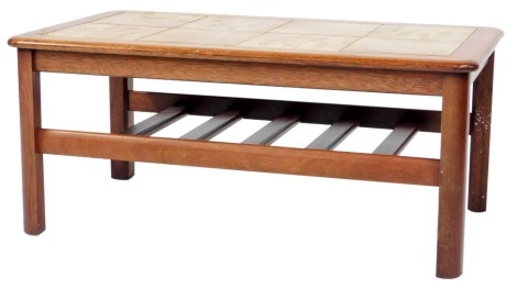 A mid century teak tile top coffee table, with slatted under tier, raised on four curved triangular legs, 40cm high, the top 51cm x 90cm.