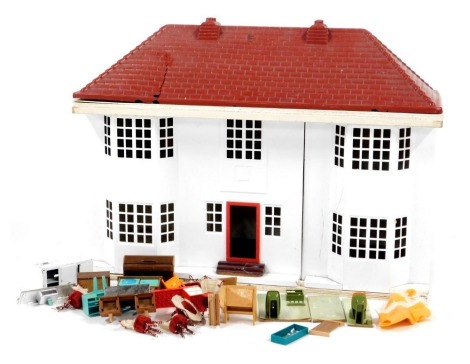 A mid century wooden and metal doll's house, of double bay front, with plastic removable roof, containing some furniture, 54cm high, 64cm wide.