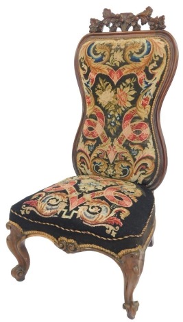 A Victorian nursing chair, with Berlin wool work upholstery.