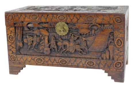 An Oriental camphor wood chest, carved with figures, floral motifs, etc., on carved bracket feet, 54cm high, 101cm wide, 48cm deep.