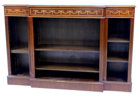 A 20thC Adam style mahogany breakfront open bookcase, the top with a moulded edge above inlaid bows and swags, the base with three sections each with two shelves, on a plinth base, 103cm high, 150cm wide, 32cm deep.