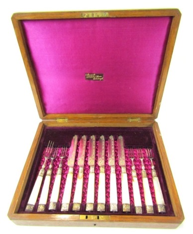 A set of six Victorian silver plated dessert knives and forks, each with a mother of pearl handle, contained in an oak case, bearing label for Sturrock, 12 St Andrews Square, Edinburgh.