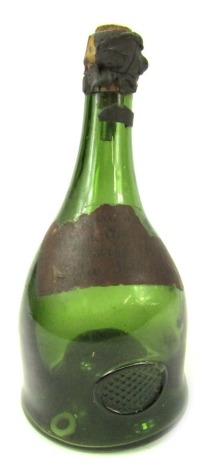 A late 19thC green glass bottle, bearing label for Grande Champagne Reserve 1898 de la Peyrouse, 25cm high.