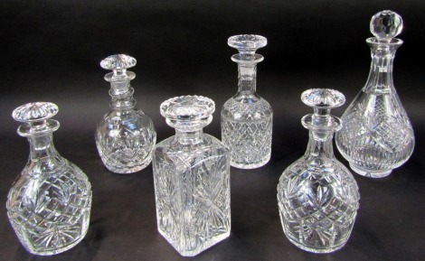 A group of cut glass decanters, to include two decanters of bottle form with stoppers, each 21cm high, a square decanter and stopper, 25cm high, etc.