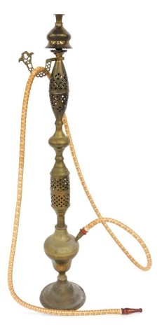 A Middle Eastern brass floor standing hookah pipe, with pierced decoration and etched floral motifs, 104cm high.