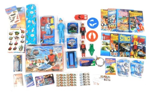 A group of Thunderbirds related ephemera, to include an Alan Tracy talking action figure, wrapping paper, Captain Scarlet Mysterious Puzzle, soap, further figures, etc.