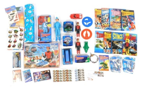 A group of Thunderbirds related ephemera, to include an Alan Tracy talking action figure, wrapping paper, Captain Scarlet Mysterious Puzzle, soap, further figures, etc.