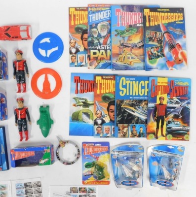 A group of Thunderbirds related ephemera, to include an Alan Tracy talking action figure, wrapping paper, Captain Scarlet Mysterious Puzzle, soap, further figures, etc. - 2