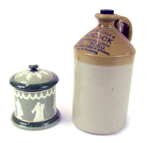 An L Adcock Peterborough stoneware flagon, 29cm high, together with a HW and R pottery tobacco jar and cover, decorated in relief with classical figures against a two tone green ground, 15cm high.