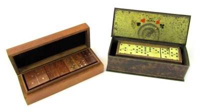 A set of wooden dominoes, contained in a hardwood case, 20cm diameter, together with a tin case containing plastic dominoes.