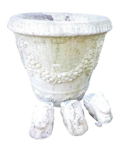 A composition plant pot, of cylindrical tapering form decorated with masks, swags, etc., 52cm high, together with three lion's head feet.