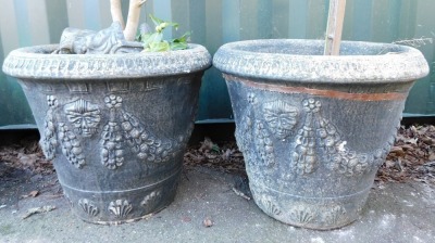 A pair of black painted composition plant pots, of cylindrical tapering form decorated with masks, swags, etc., 50cm high, containing plants, together with two pairs of three lion's head feet. - 2