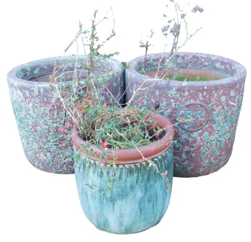 A pair of garden planters, of circular form, in burgundy with reactive blue glaze, each bearing a roundel with the initials ER, 39cm high, together with a further plant pot.