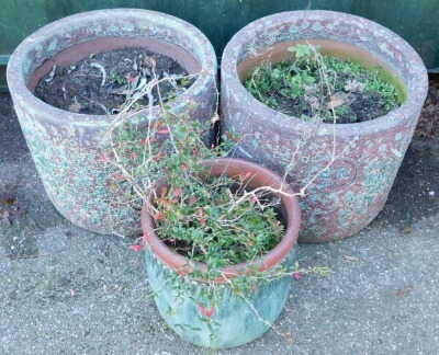 A pair of garden planters, of circular form, in burgundy with reactive blue glaze, each bearing a roundel with the initials ER, 39cm high, together with a further plant pot. - 2