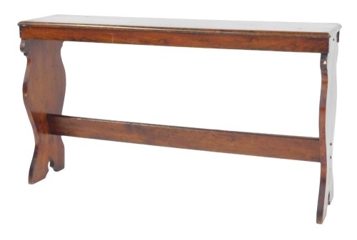 An oak refectory bench, the rectangular top above two shaped end supports united by a stretcher, 64cm high, 113cm wide, 26cm deep.