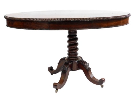 A Regency rosewood breakfast table, the oval top with a beaded border, raised on a spiral turned column on scrolling legs with carved leaf decoration, on castors, 65cm high, the top 126cm x 80cm. (AF)