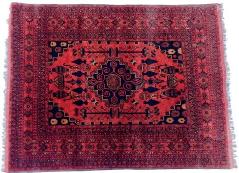 A Persian style rug, red ground, decorated with central medallion within multiple borders, 200cm x 153cm.